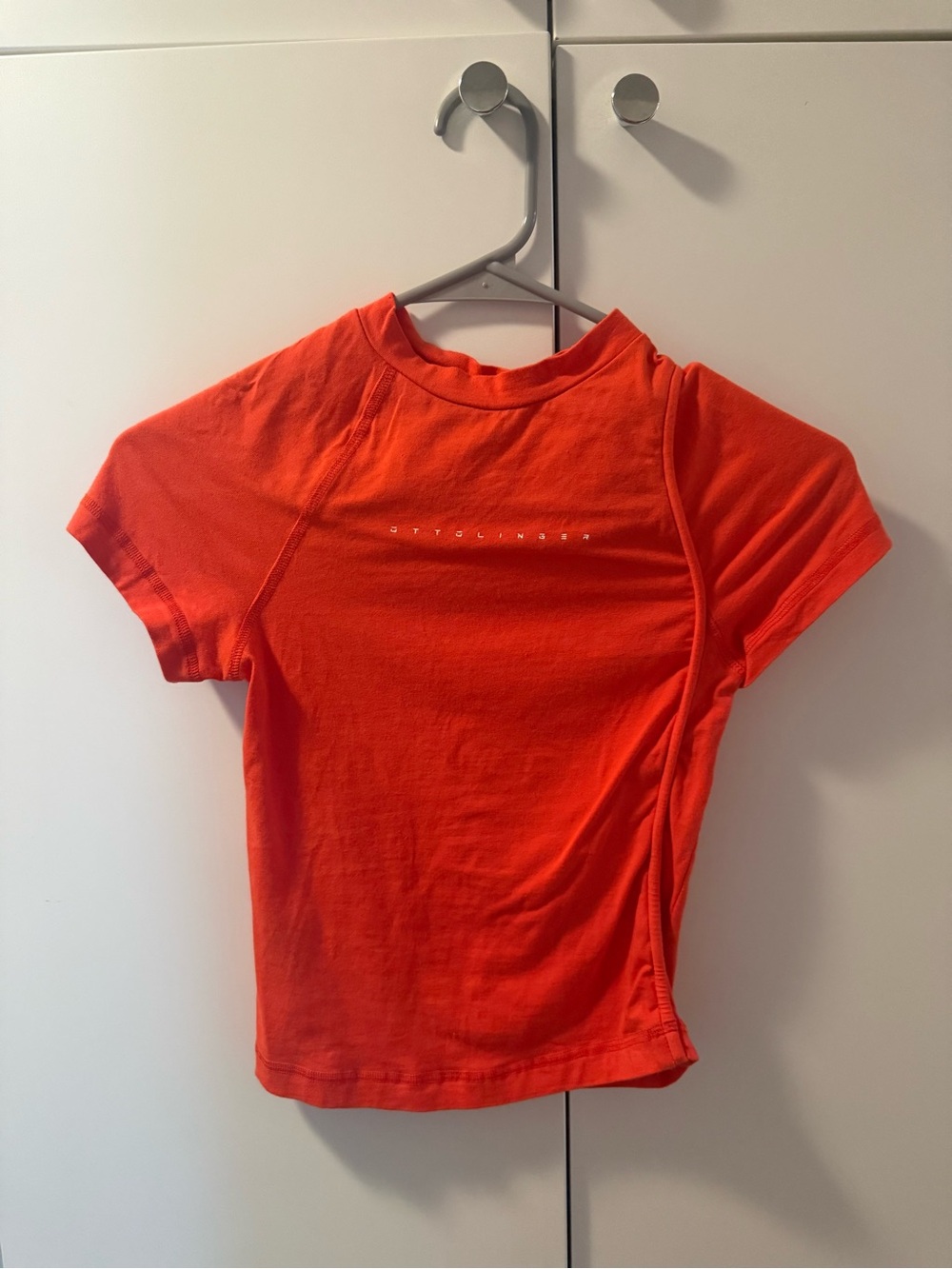 OTTOLINGER REDDISH FORM FITTING TOP WITH DETAILED PIPING